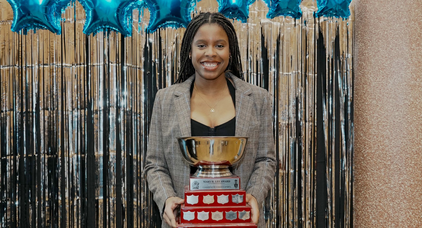 Beluchi Okeke holds a trophy
