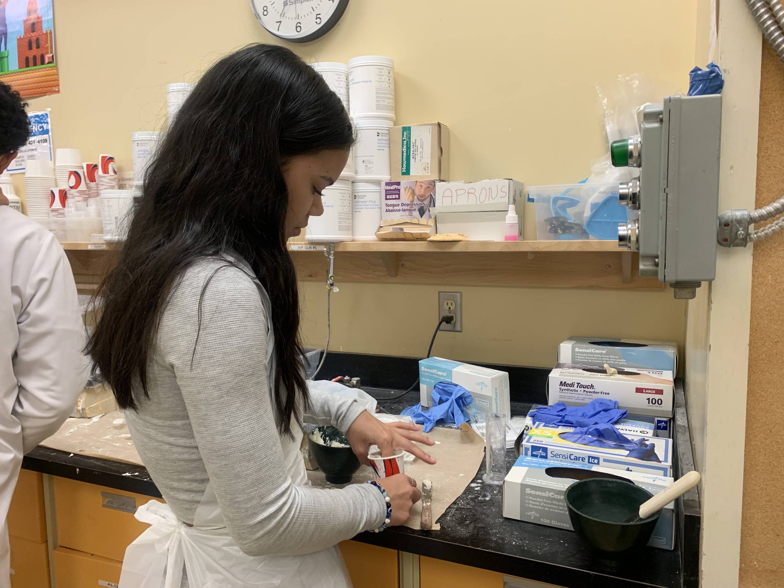 A student prepares molds used for dental impressions at PLANS