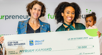 Karen Greve Yonge hands Myriam Kamako a ten thousand dollar cheque