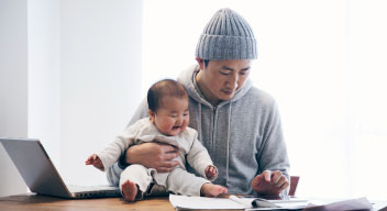 Man with baby looking at laptop