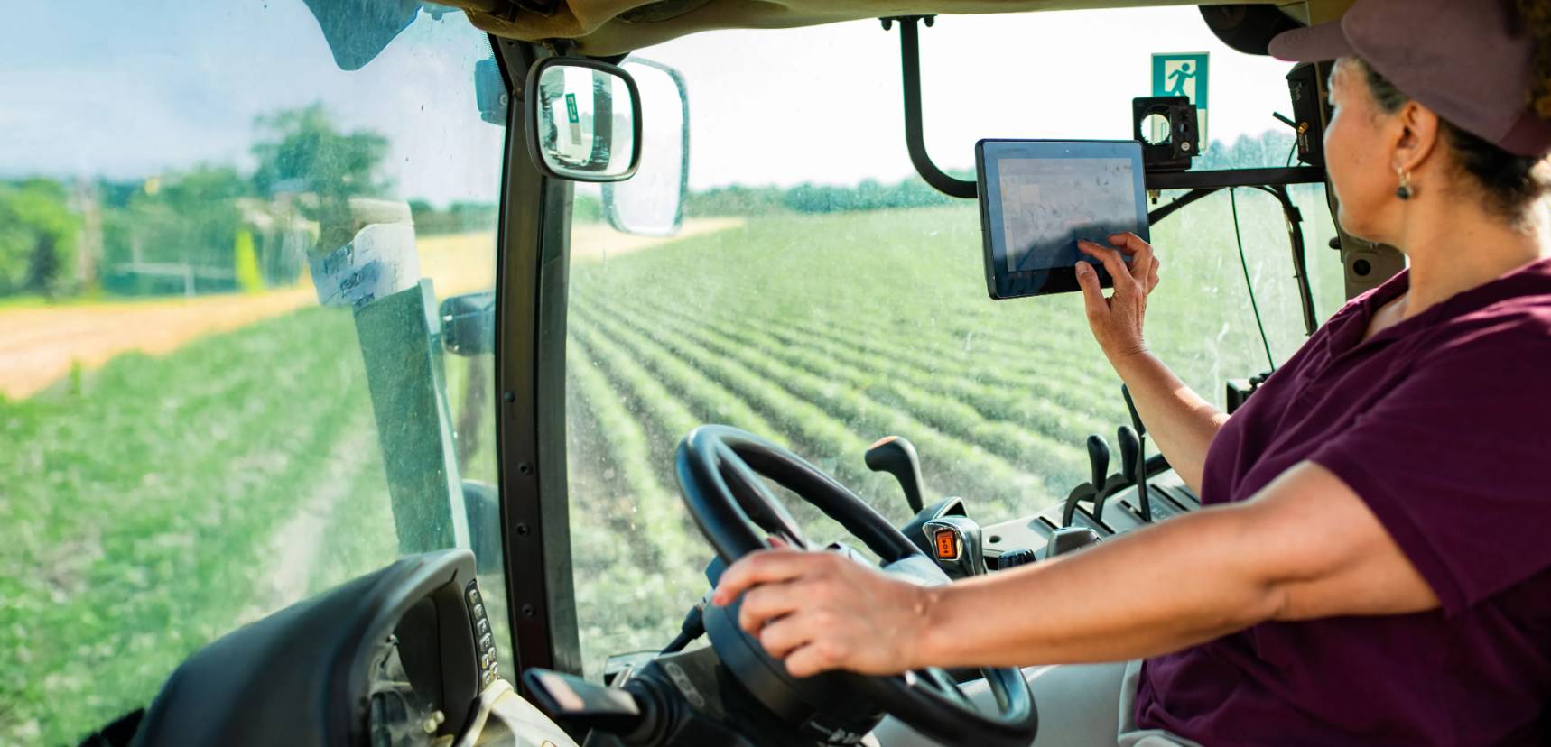 farmer in machine cultivating crops