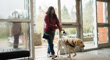 Woman walking with a service dog